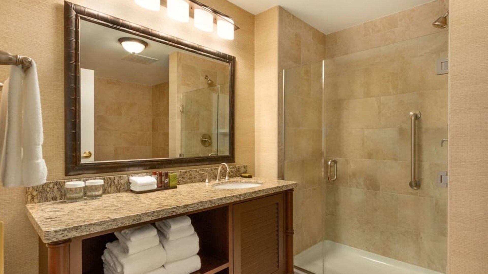 Private guest bathroom with shower at Embassy Suites By Hilton Savannah.