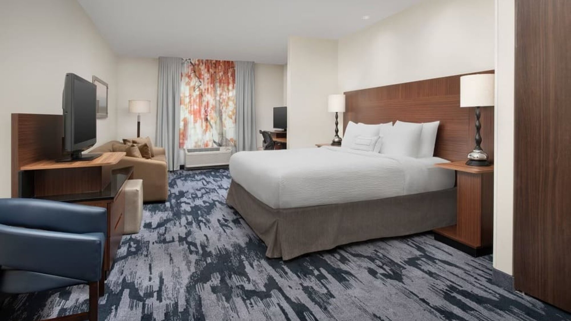 King bedroom with TV and work space at Fairfield Inn & Suites by Marriott Baltimore BWI Airport.