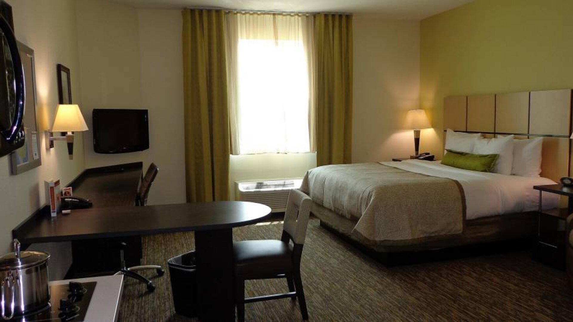 Day use room with work desk and kitchen at Candlewood Suites Odessa.