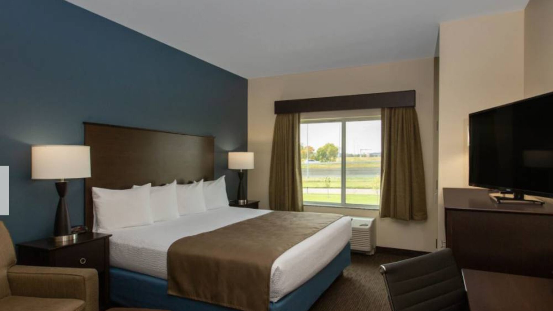Day use room with work desk and sofa at AmericInn By Wyndham Sioux Falls North.