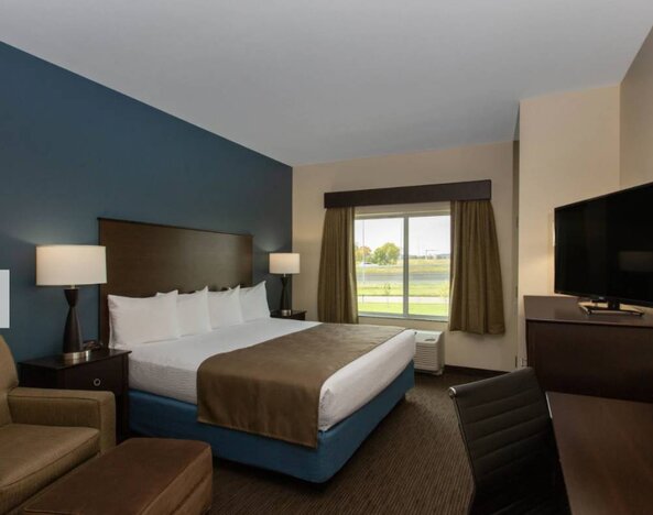 Day use room with work desk and sofa at AmericInn By Wyndham Sioux Falls North.