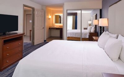 Delux king bed with TV at Homewood Suites By Hilton Dallas-Lewisville.