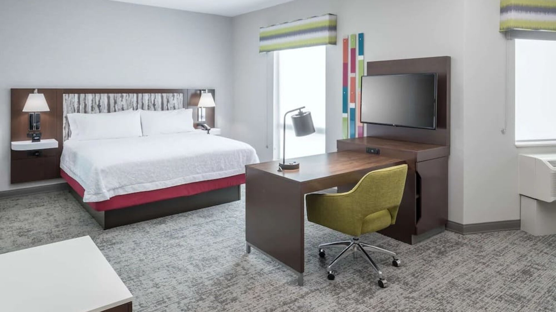 Delux king bed with TV at Hampton Inn & Suites Cape Canaveral Cruise Port.