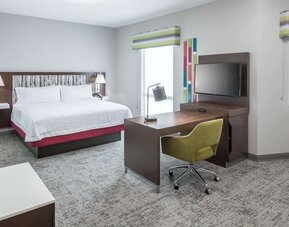 Delux king bed with TV at Hampton Inn & Suites Cape Canaveral Cruise Port.