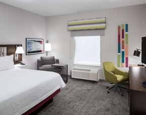 King bed with natural light at Hampton Inn & Suites Cape Canaveral Cruise Port.