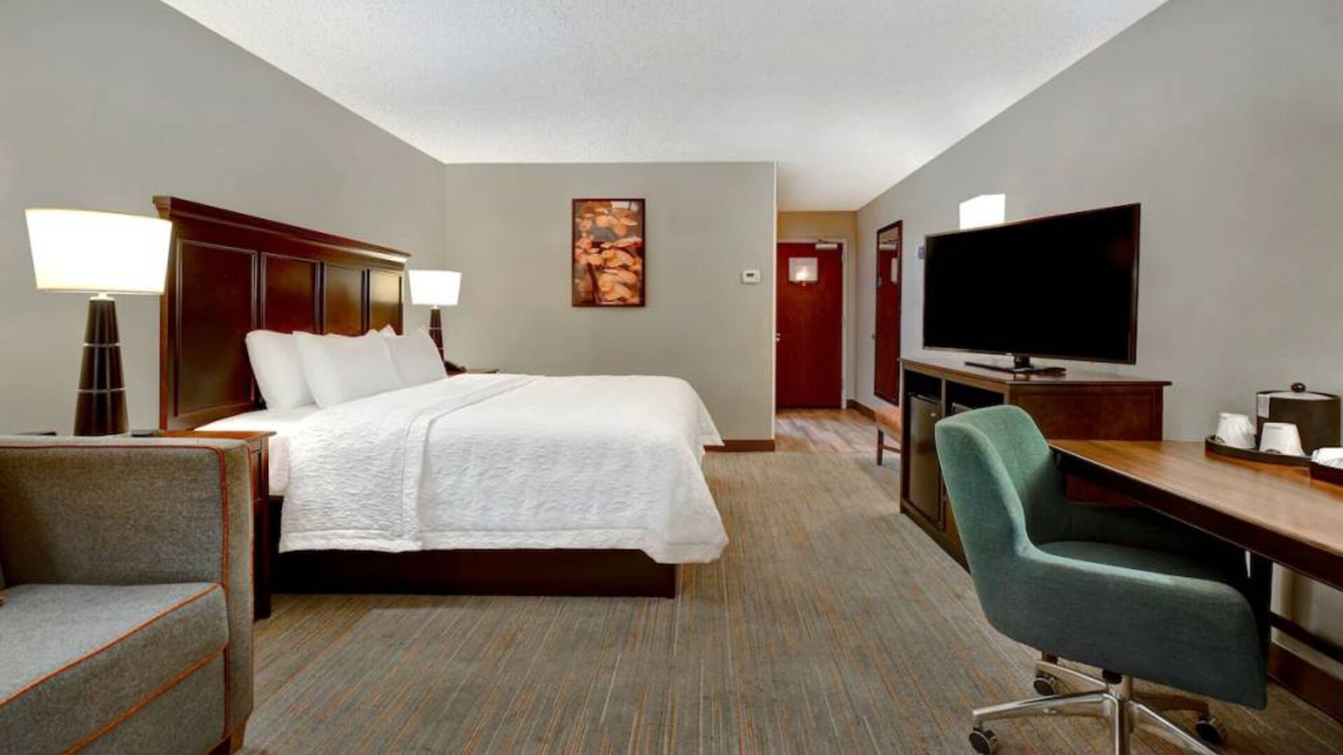 Day use room with work desk and sofa at Hampton Inn & Suites Alexandria.