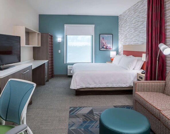 Delux king room with natural light at Home2 Suites By Hilton Cape Canaveral Cruise Port.