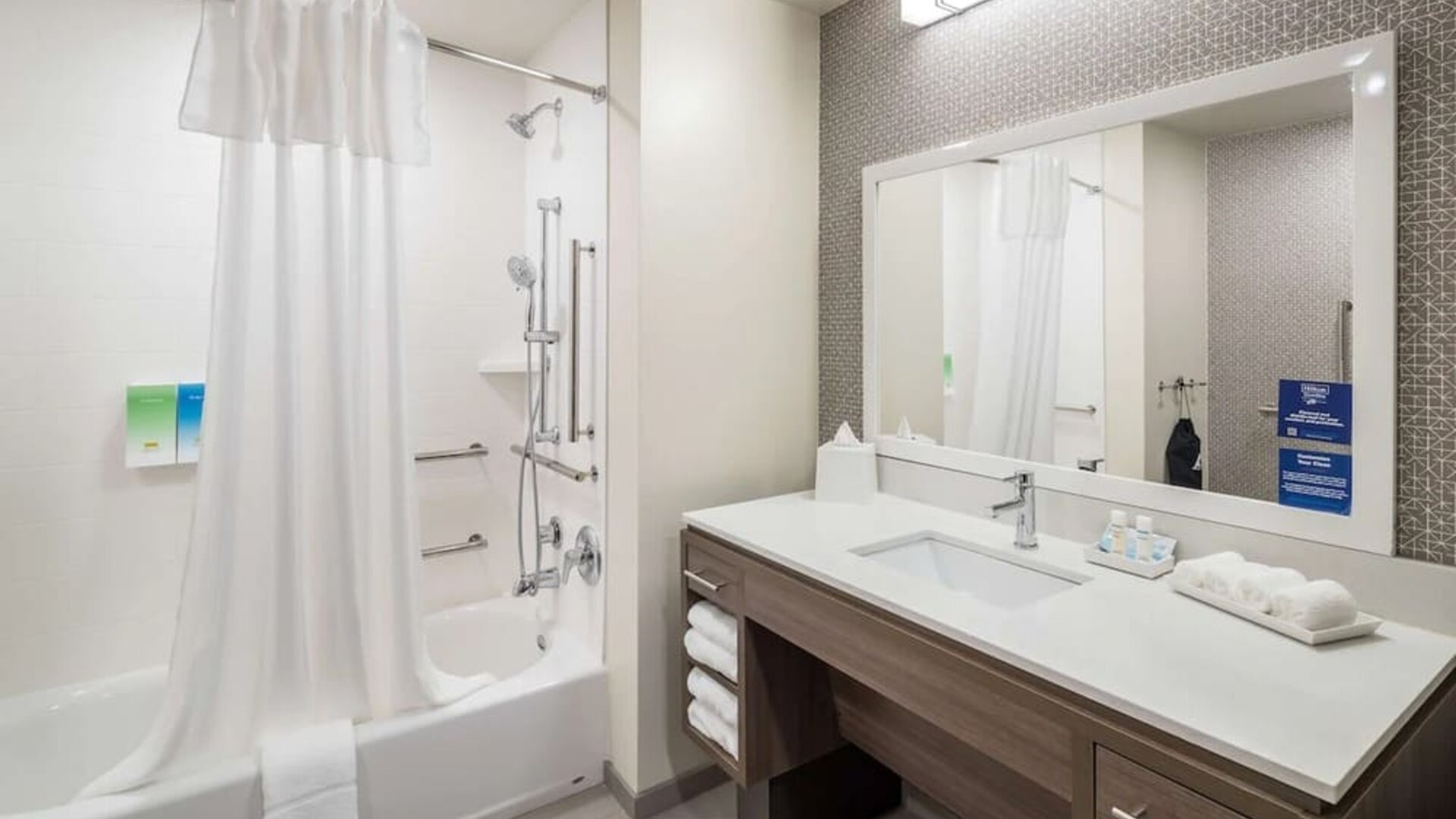 Private guest bathroom with shower and bath at Home2 Suites By Hilton Cape Canaveral Cruise Port.