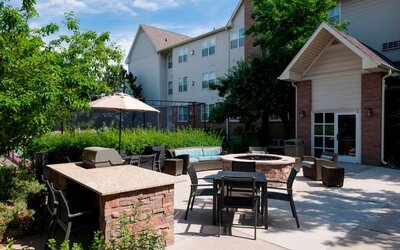 Fire pit and BBQ grill area at Residence Inn By Marriott Denver Highlands Ranch.