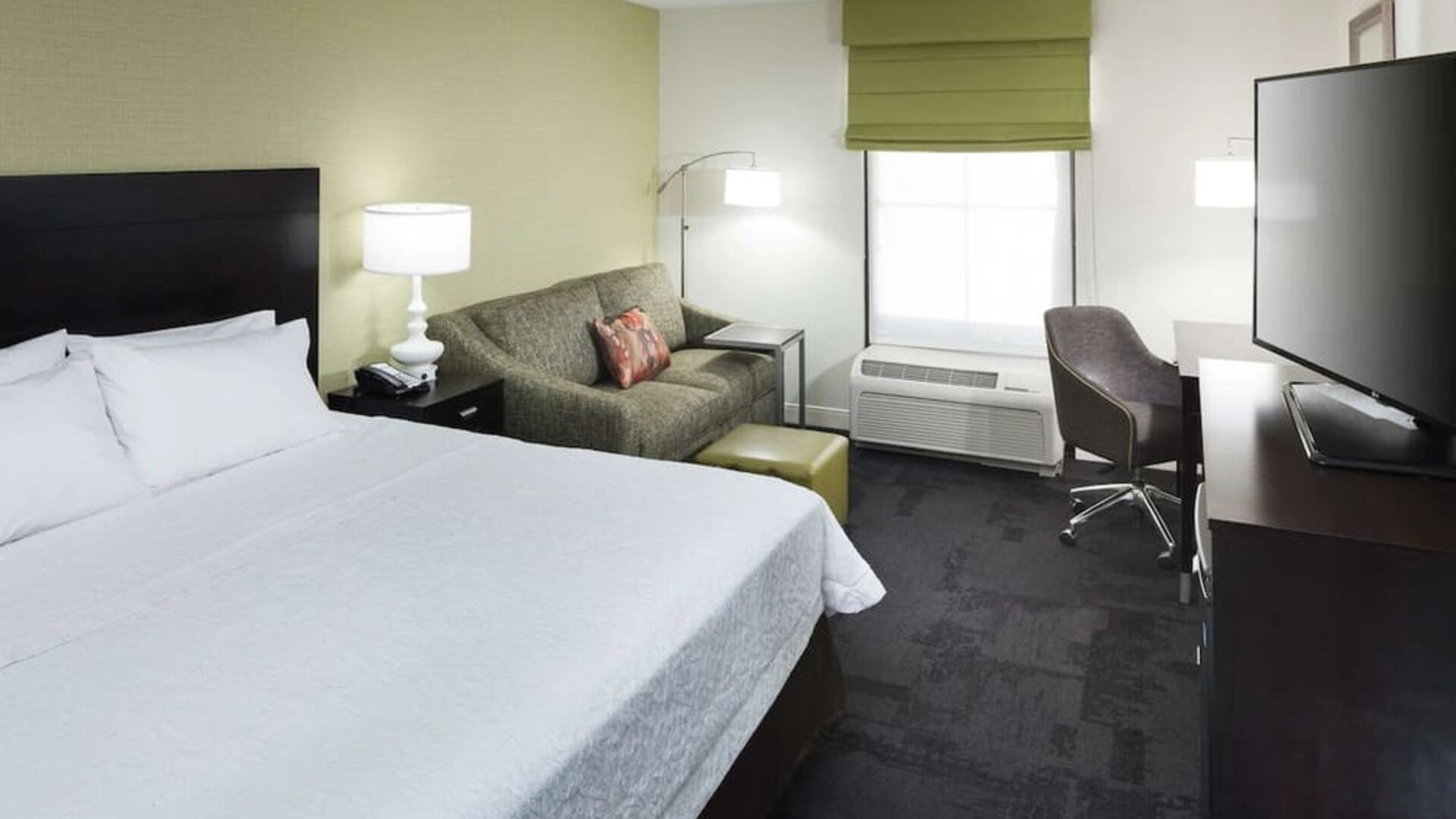 Day use room with work desk and natural light at Hampton Inn & Suites Gainesville-Downtown.