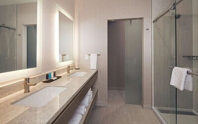 Guest bathroom with shower at H Hotel Los Angeles, Curio Collection By Hilton.