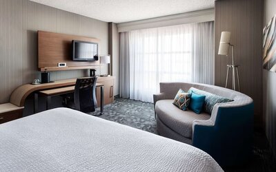 Delux king bed with TV at Sonesta Emeryville - San Francisco Bay Bridge.