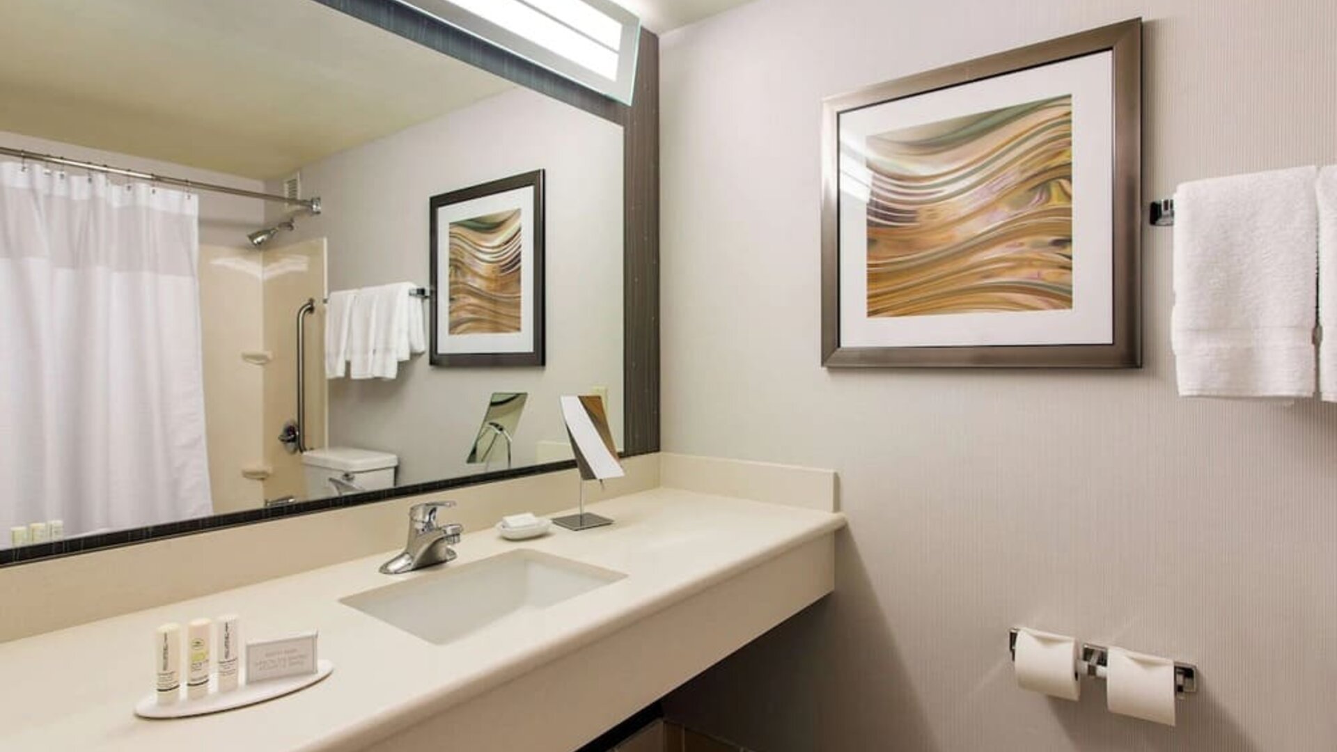 Guest bathroom with shower at Sonesta Emeryville - San Francisco Bay Bridge.