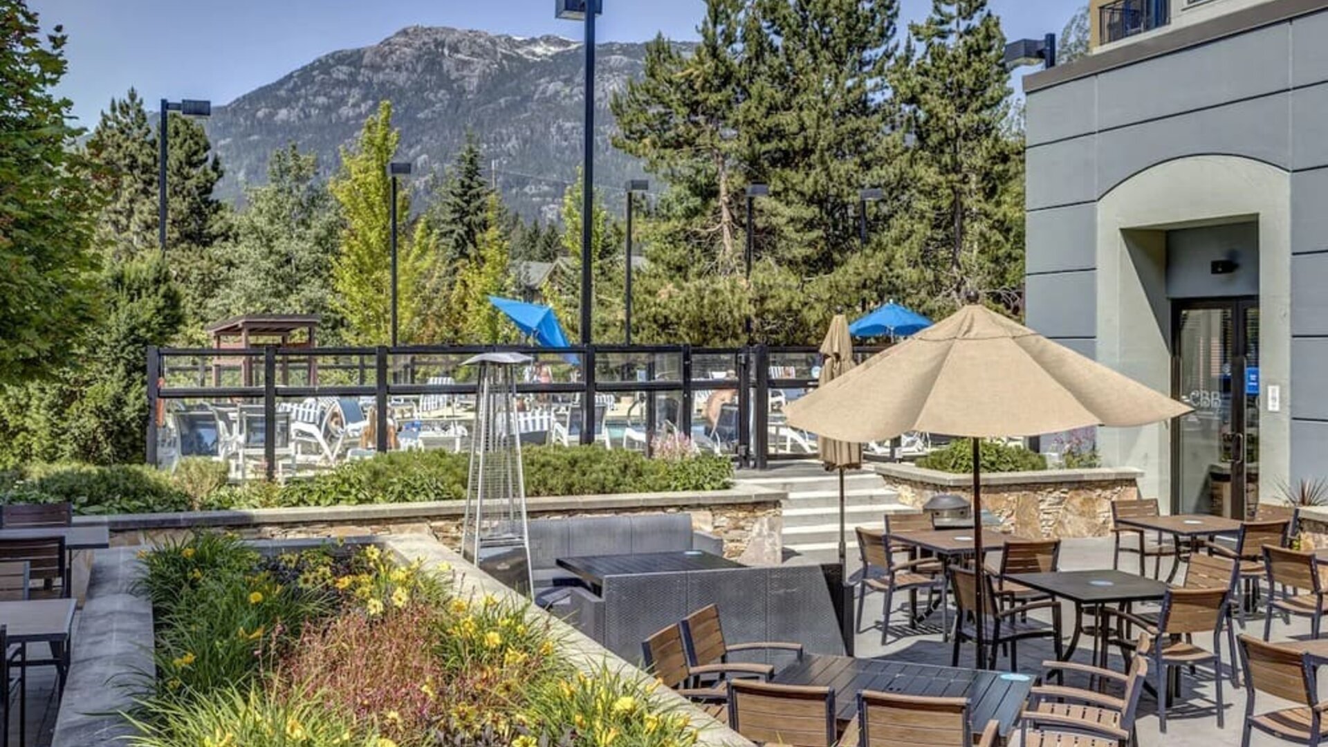 Outdoor terrace set in a lovely garden at Hilton Whistler Resort & Spa.