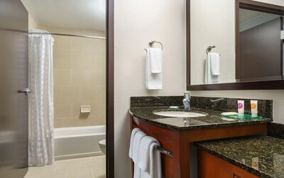 Guest bathroom with shower and tub at Hyatt PLACE Fort Lauderdale Airport - South & Cruise Port.