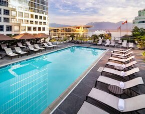 Relaxing outdoor pool with lounge chairs at the Fairmont Waterfront.