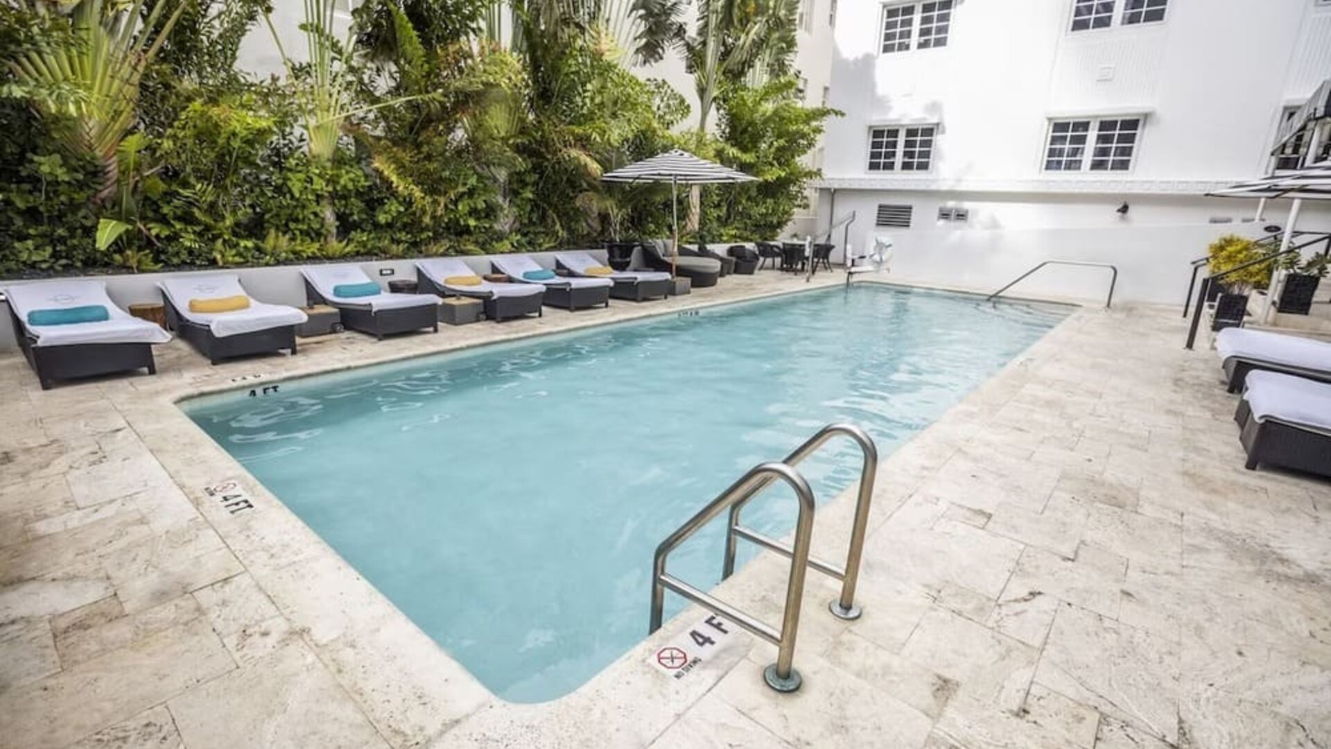 Relaxing pool area with sun loungers at Hotel Croydon.