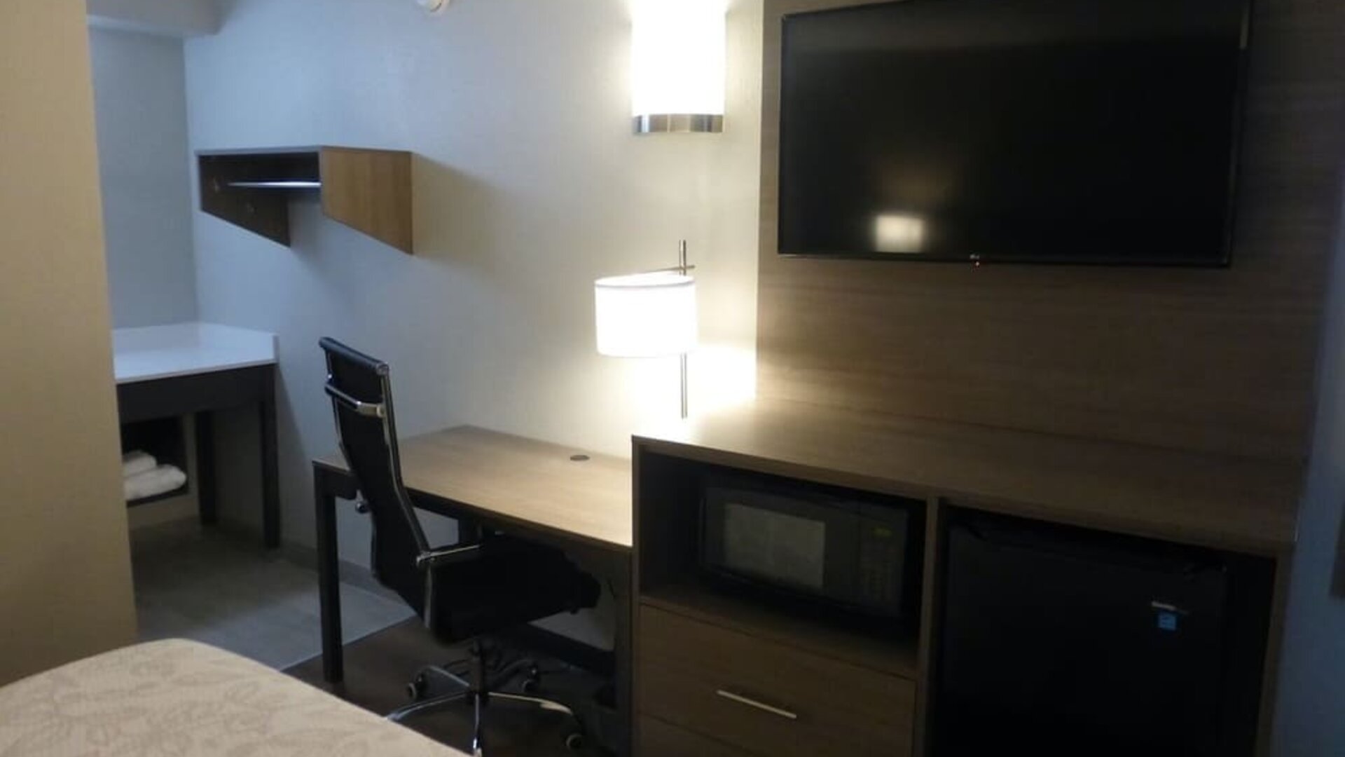 Day room with TV and work desk at Red Roof Plus Bourbonnais.