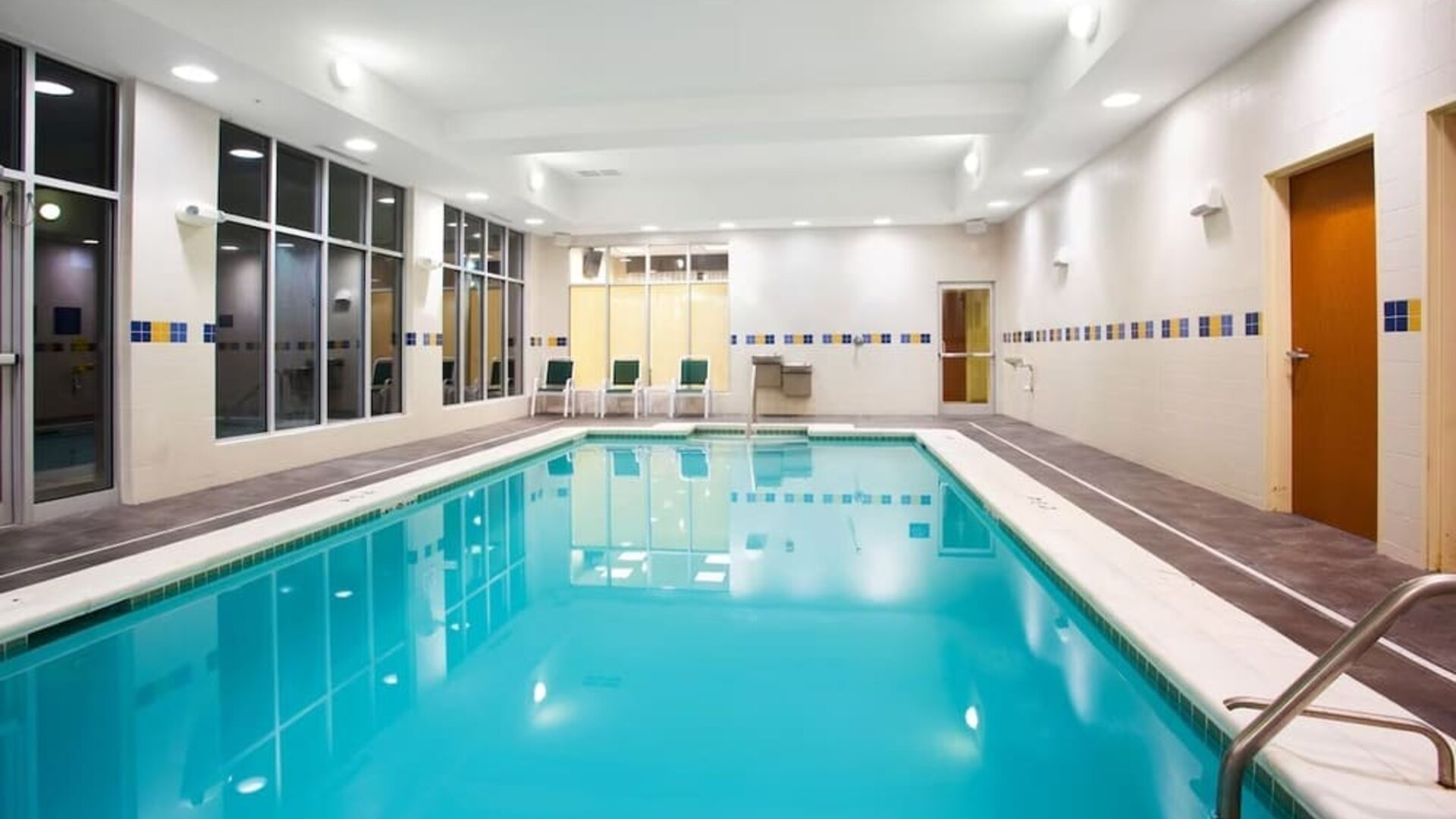 Relaxing indoor pool with seating area at Holiday Inn Aurora North- Naperville.