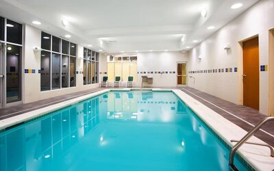 Relaxing indoor pool with seating area at Holiday Inn Aurora North- Naperville.