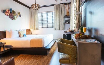 Cozy king bed with work space at Hotel Chelsea, A South Beach Group Hotel.