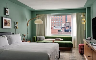 Day room with kitchenette and lounge area at Romer Hell's Kitchen.