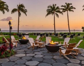Garden with seating area ideal for coworking at Ko'a Kea Resort On Po`ipu Beach.