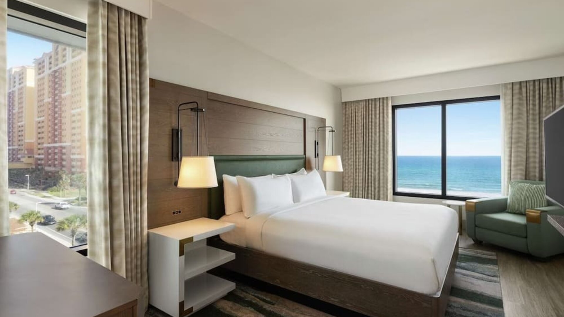 Day use room with king bed and sea view at Embassy Suites By Hilton Panama City Beach Resort.
