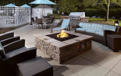 Sonesta ES Suites Cincinnati - Blue Ash’s patio area features a fire pit, plus tables and chairs, and a barbecue.