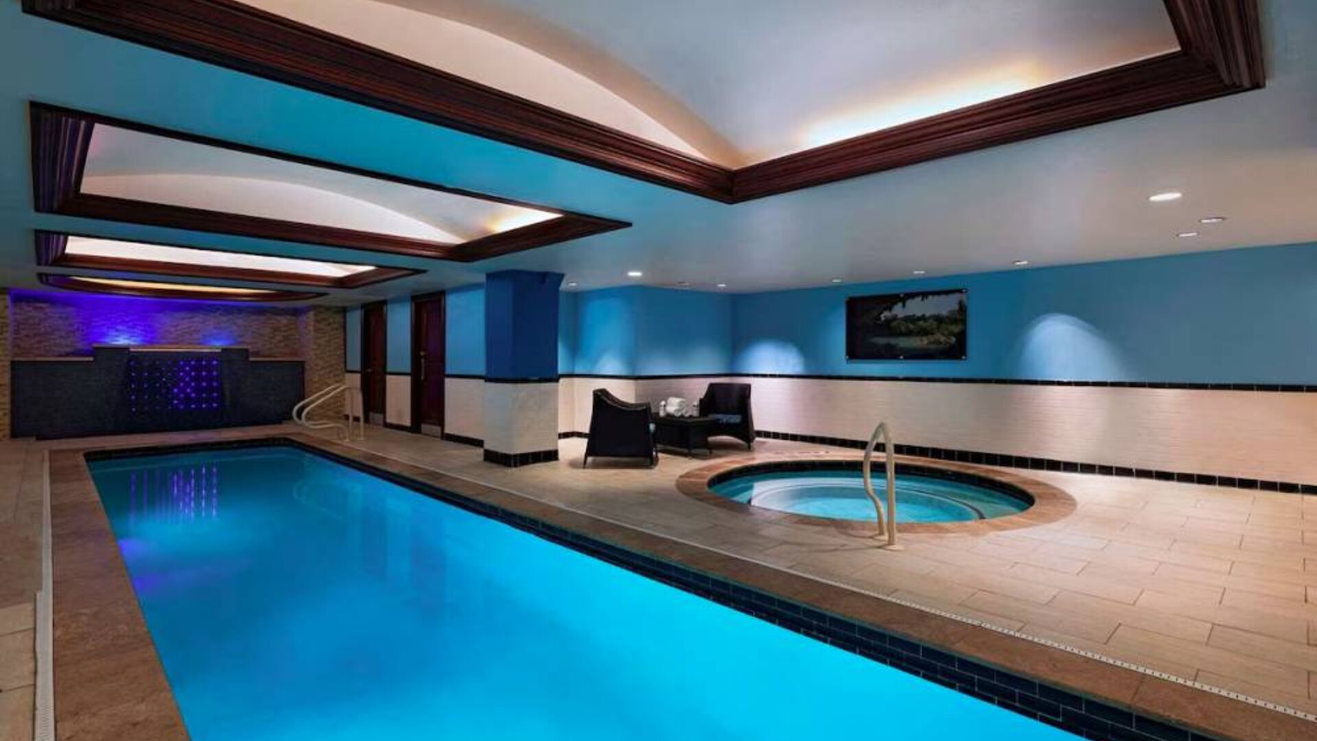 The Stephen F Austin Royal Sonesta Hotel’s narrow indoor pool has two armchairs nearby, plus a hot tub.