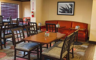The hotel’s breakfast area has a mix of table sizes and both chairs and sofa seating.