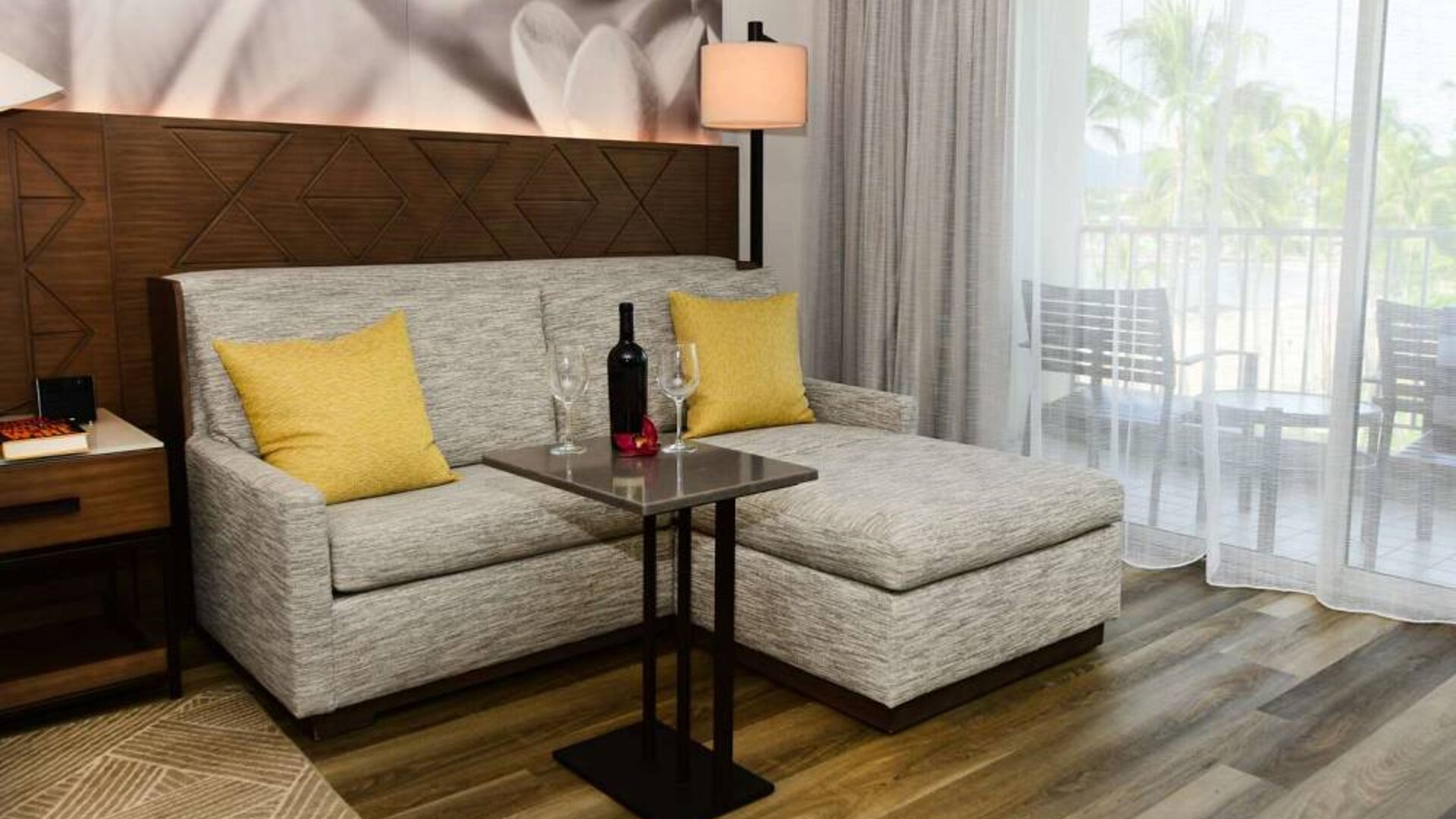 Guest room in Royal Sonesta Kaua'i Resort Lihue, featuring corner sofa, coffee table, and balcony.