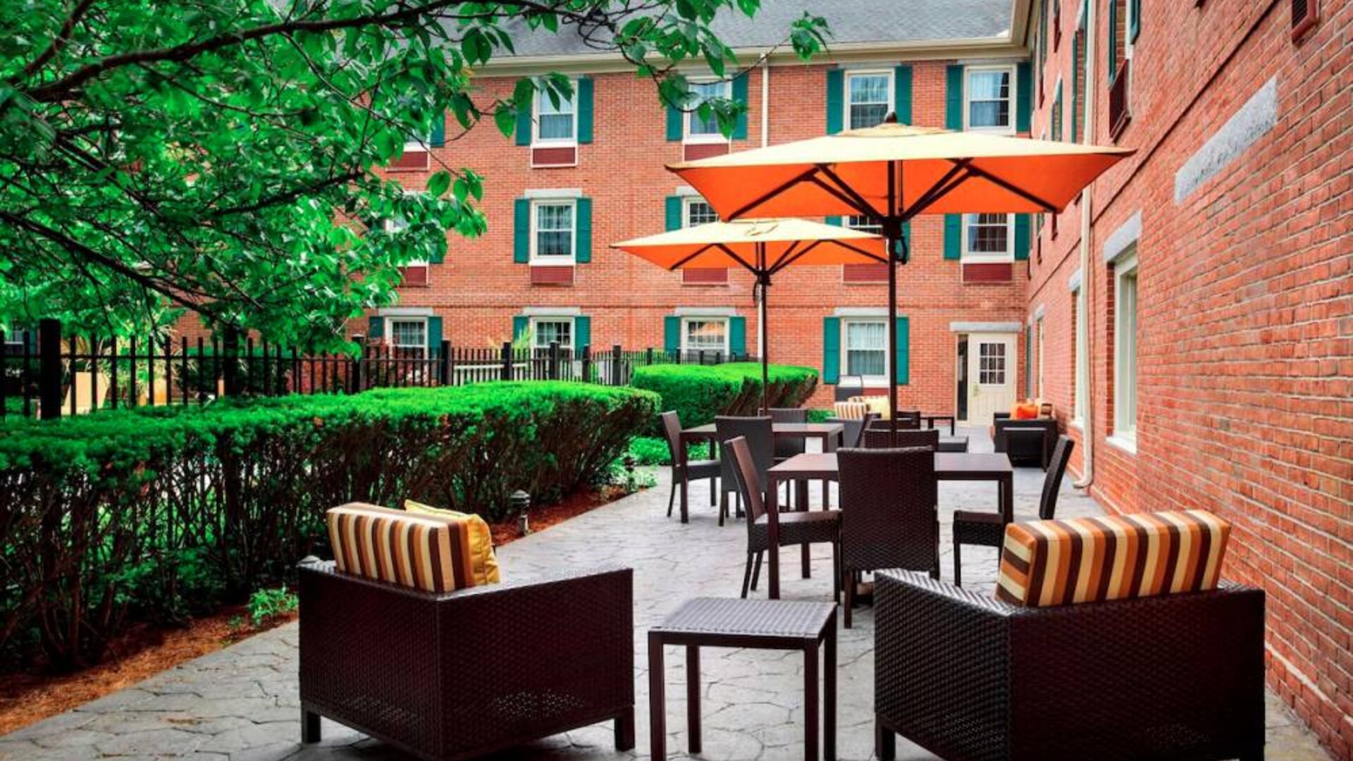 The hotel’s patio has armchairs and coffee tables, plus shaded tables and chairs.