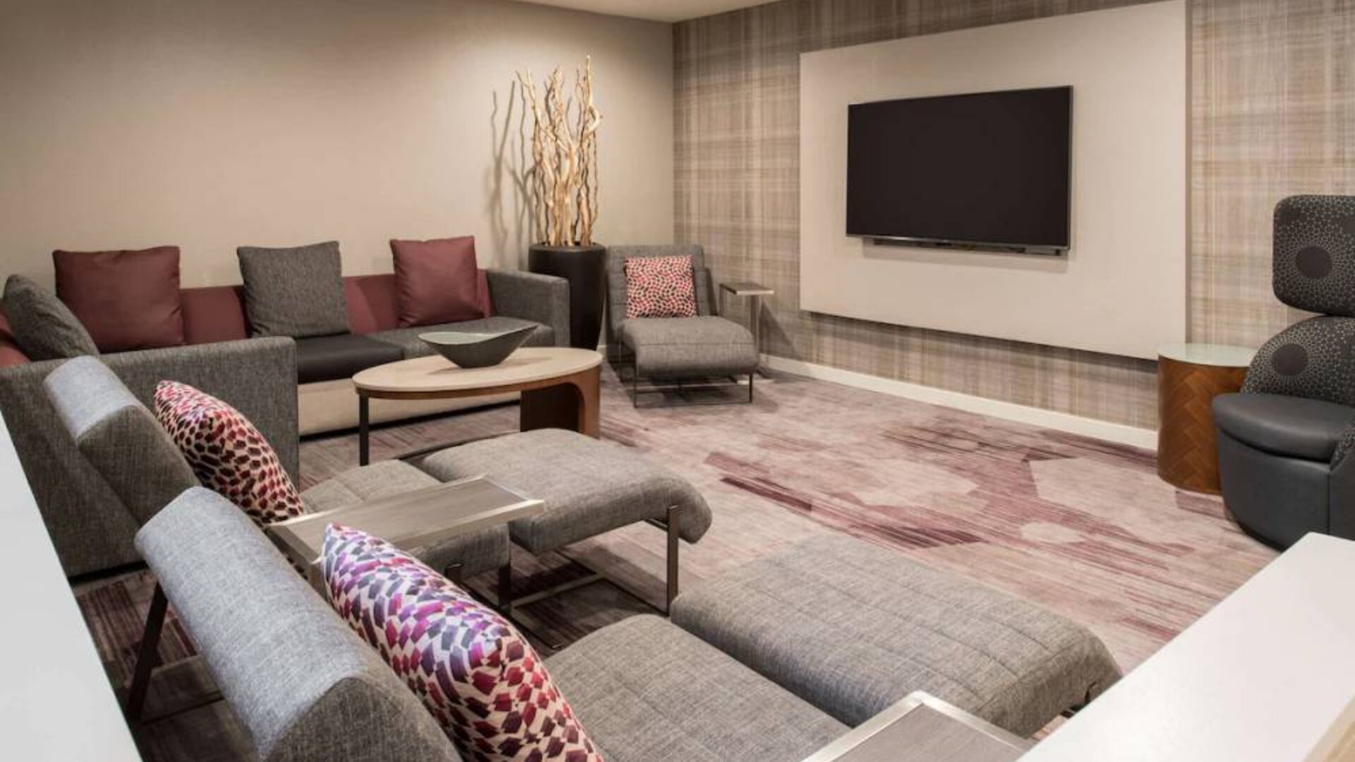 The lobby in Sonesta Select Seattle Bellevue Redmond features an enormous television, comfortable seating and coffee tables.