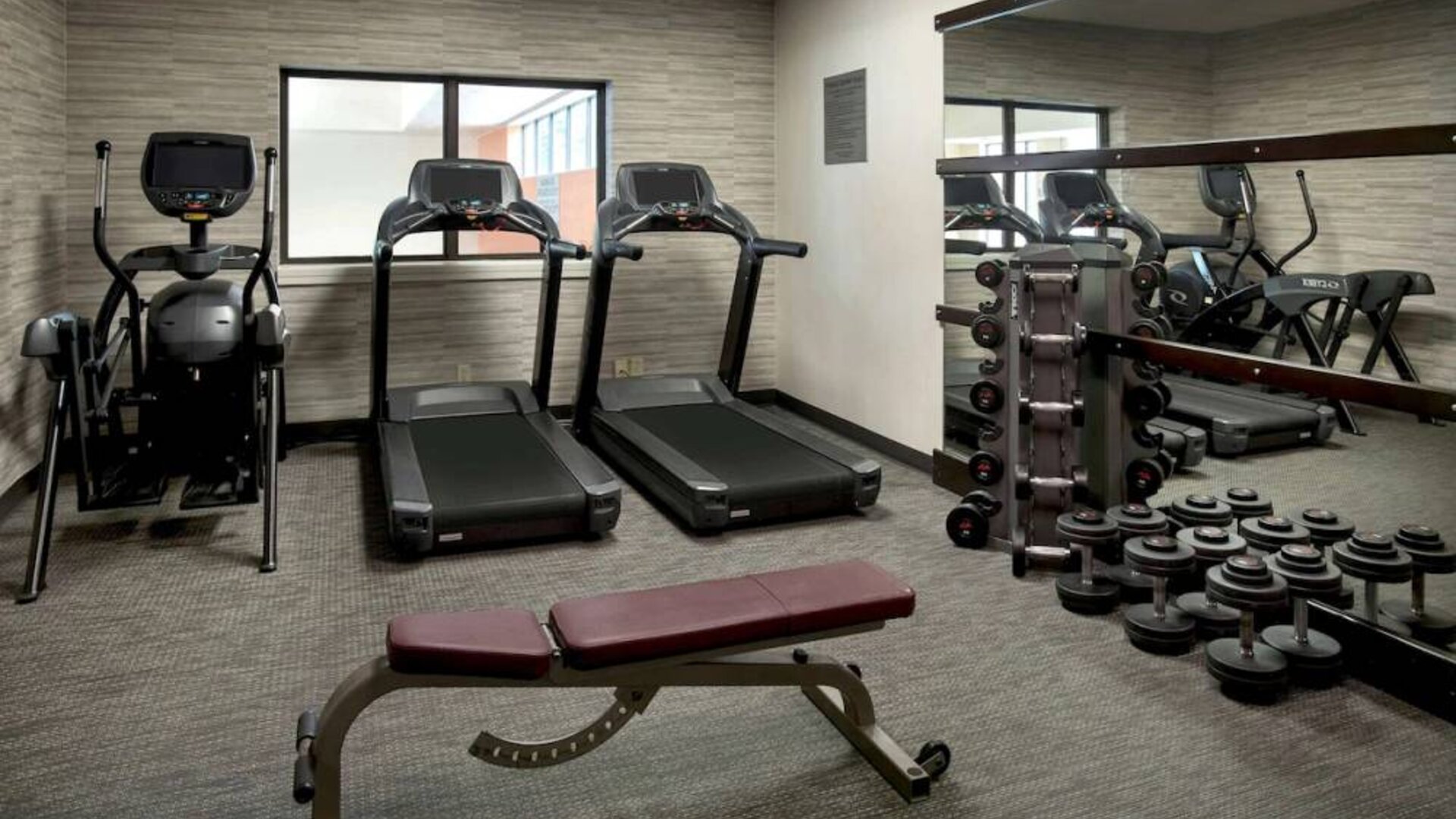 The hotel’s fitness center has treadmills, an elliptical machine, bench, and assorted free weights.
