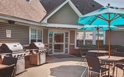 The hotel’s patio area includes shaded tables and chairs, as well as multiple barbecues.
