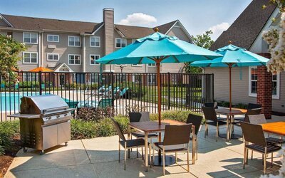 The hotel’s patio has shaded tables and chairs next to a barbecue, with the swimming pool only steps away.