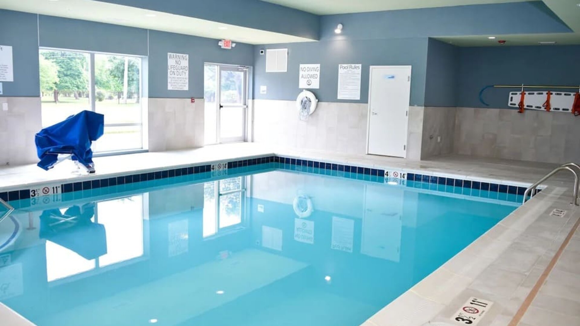 Indoor pool with chairs at Holiday Inn Express & Suites Bensenville - O'Hare.