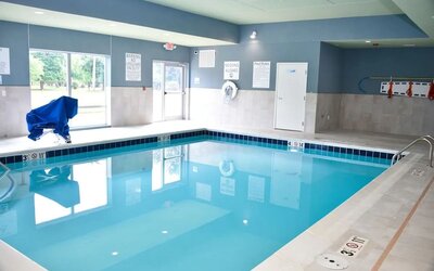 Indoor pool with chairs at Holiday Inn Express & Suites Bensenville - O'Hare.