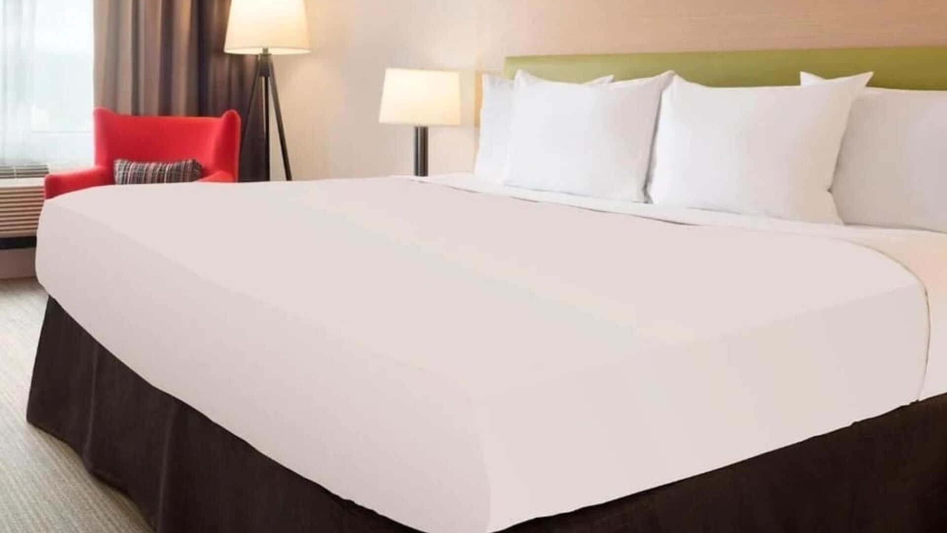 King bed with natural light at Country Inn & Suites By Radisson, Chicago O'Hare South.
