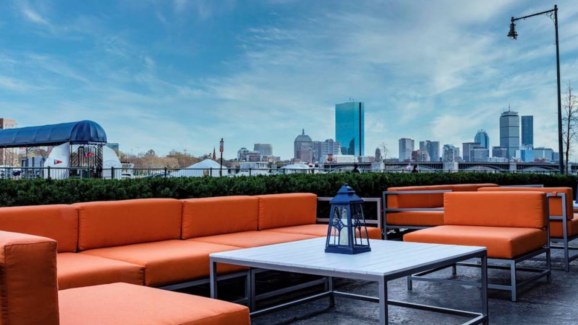 Royal Sonesta Boston’s patio provides comfortable outdoor seating and large coffee tables.