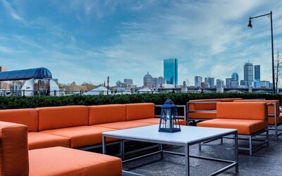 Royal Sonesta Boston’s patio provides comfortable outdoor seating and large coffee tables.