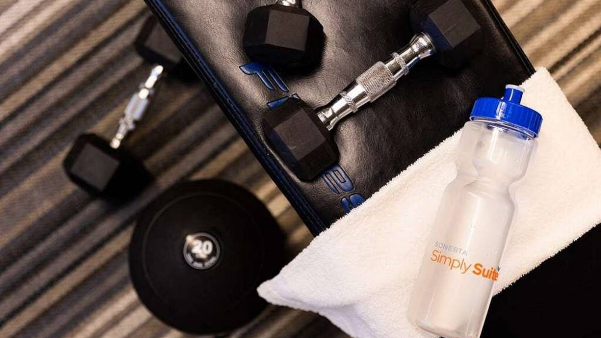 Sonesta Simply Suites Dallas Galleria’s fitness center includes a range of free weights for guests to use (including on a bench).