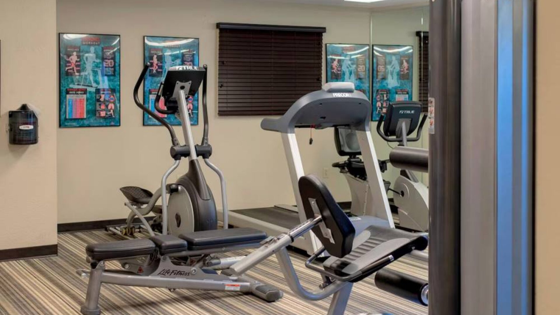 Sonesta Simply Suites Pittsburgh Airport’s fitness center is equipped with an assortment of exercise machines and a bench for those using weights.