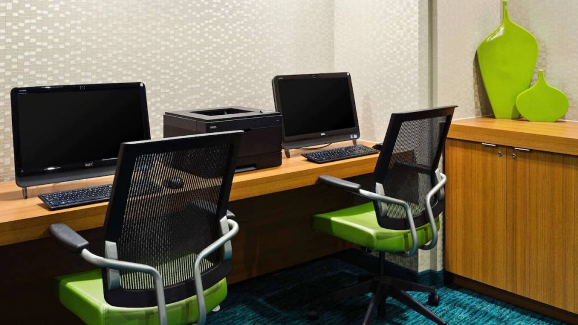 Sonesta Select Seattle Renton business center, with two computer workstations and a printer between them.