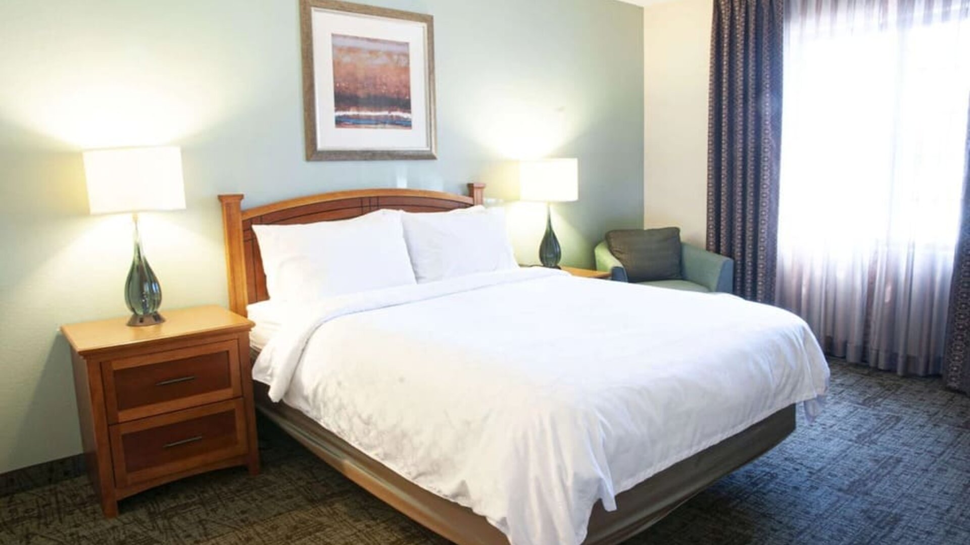 Sonesta ES Suites San Antonio Northwest - Medical Center double bed guest room, including armchair, and plenty of natural light from the large window.