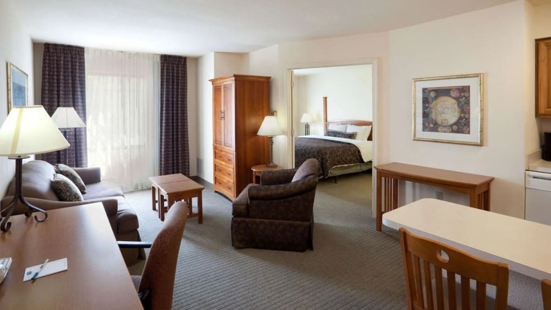 Double bed guest room in Sonesta ES Suites San Antonio Northwest - Medical Center, featuring sofa and armchair, plus workspace desk and chair.