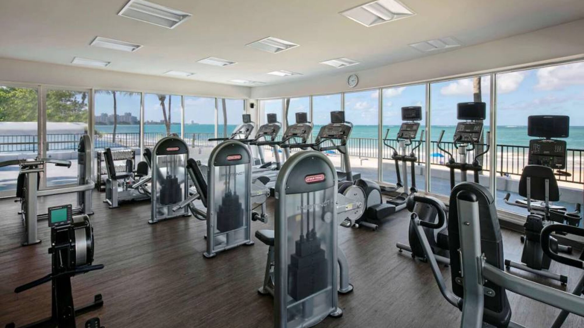 The fitness center in Royal Sonesta San Juan is equipped with a large array of exercise machines, and large windows overlooking the beach.