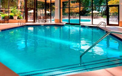 The hotel’s indoor pool has chairs by the side and a direct water link to the outside pool.