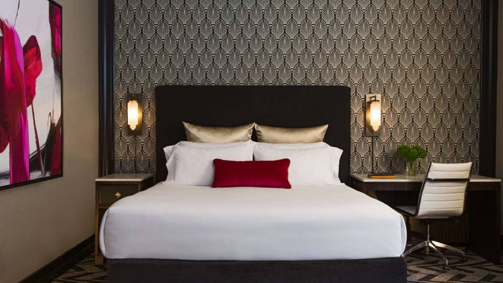 The Allegro Royal Sonesta Hotel Chicago Loop double bed guest room, with art on the wall and a workspace desk and chair.